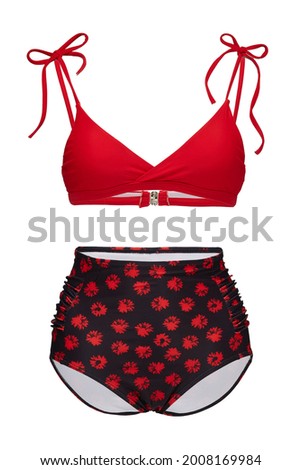 Detail shot of bright two-piece swimsuit composed of red bra with thin shoulder straps and black high-waisted panties with red floral print. Stylish swimming suit is isolated on the white background. Royalty-Free Stock Photo #2008169984