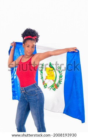 Latina woman holding a Guatemalan flag behind her