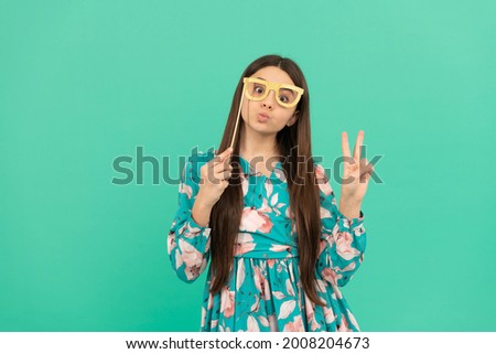 Stay cool. Cool girl hold booth glasses showing victory hand. Enjoying disguise party