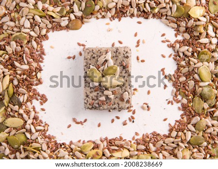 A small portion of halva on a white plate next to the ingredients