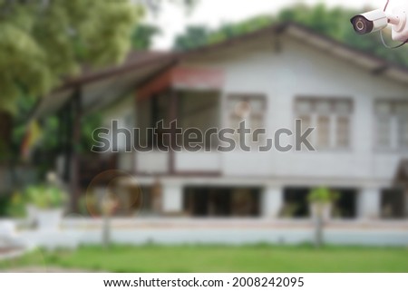 CCTV security camera with background blurred house and lens flare edited. concept home security surveillance                        