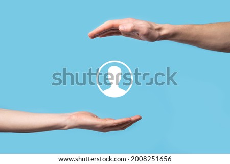Hand holds user person icon interface on blue background.User symbol for your web site design, logo, app, UI.Banner.