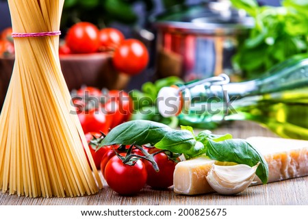 Spaghetti tomatoes basil garlic olive oil and parmesan cheese. Royalty-Free Stock Photo #200825675