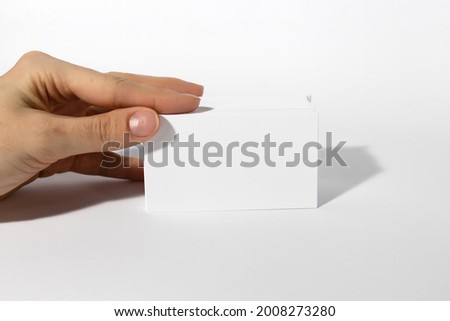 Female hands with cutaway, blank menu, discount card, business card on  white background with copy space. Template for design Mockup