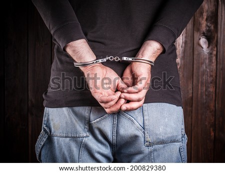 man hands in handcuffs  Royalty-Free Stock Photo #200829380