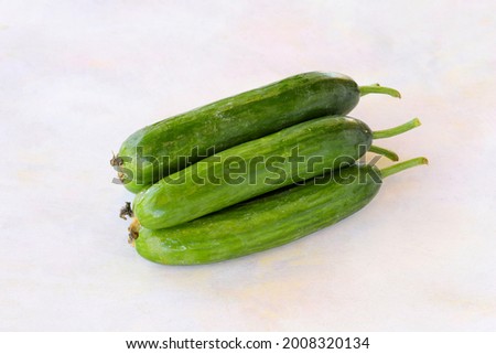 Cucumbers on a white wooden background