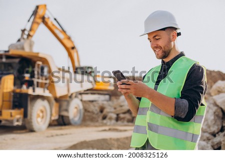 Male worker with bulldozer in sand quarry Royalty-Free Stock Photo #2008325126