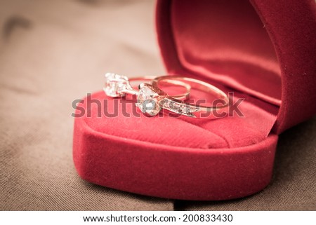 Wedding rings in a box on a brown background