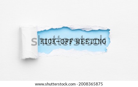 The text KICK-OFF MEETING appearing behind torn yellow paper Royalty-Free Stock Photo #2008365875