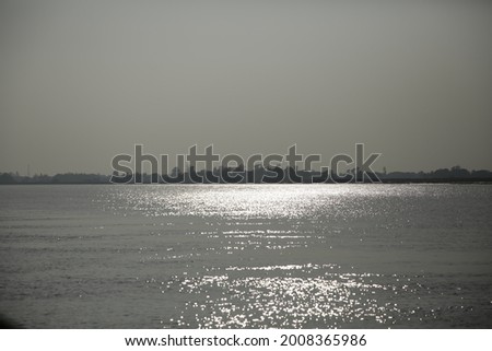 Sun reflection on water - Water waves with sparkling light - Sun glints at Bhitarkanika National Park Royalty-Free Stock Photo #2008365986