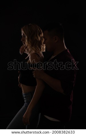 a man and a woman dance together to music in the dark