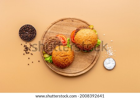 Sandwiches hamburger with chicken burger and green salad. Overhead view Royalty-Free Stock Photo #2008392641