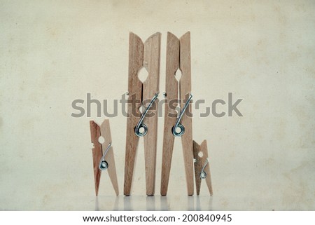Playground family. Abstract: The family of linen clothespins. Man, woman with children. Vintage paper background. Soft focus.