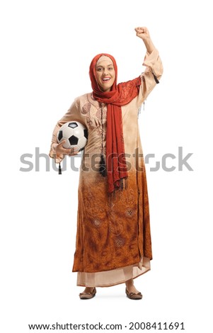 Female in ethnic clothes holding a football and cheering isolated on white background