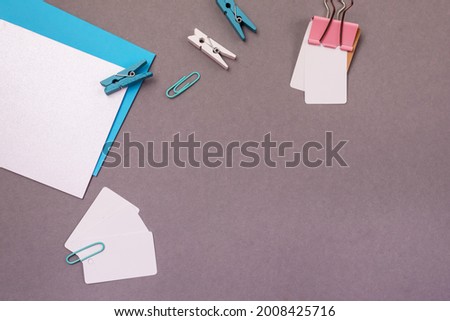 Minimal Styled Flat lay with white blank with paper clips Mock up top view Horizontal