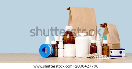 Online pharmacy. prescription drugs and over the counter medication ready for delivery to customers. Pills and spray white mockup containers and buff paper bags on table. Drugstore shopping Royalty-Free Stock Photo #2008427798