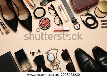 Fashionable male and female accessories on beige background, flat lay. Space for text Royalty-Free Stock Photo #2008428230
