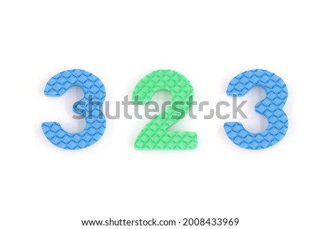 number 323 isolated on white background. Colorful letters on background close up. Alphabet toy. Number three hundred and twenty three.