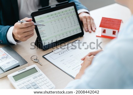 Real estate agent meeting customer with insurance policy about house contract.
