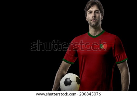 Portuguese soccer player, celebrating on a black background.