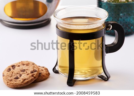 Comforting cup of hot tea by two cookies with chocolate chips Tea time.