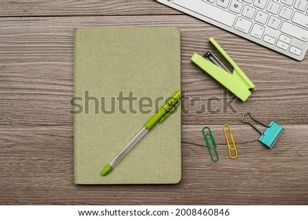 Top view of business desk with notepad keyboard and pen, eye glasses,Staples,pen Copy space.above shot