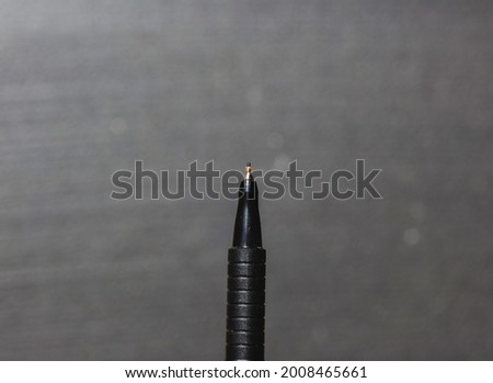 isolated black pen on a black background. writing concept for school education and business.
