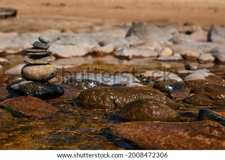 sea view with boulders and small stones stacked on top of each other . High quality photo