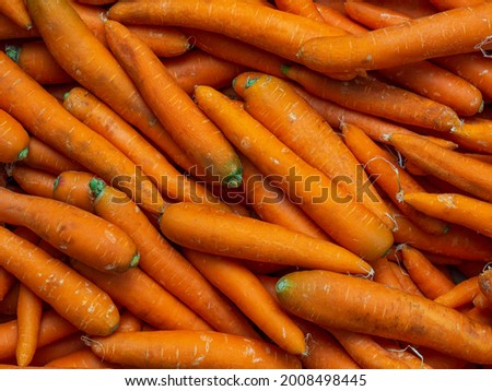 Background of washed orange carrots without green tops close-up in full screen. Autumn harvest concept, vegetables for sale