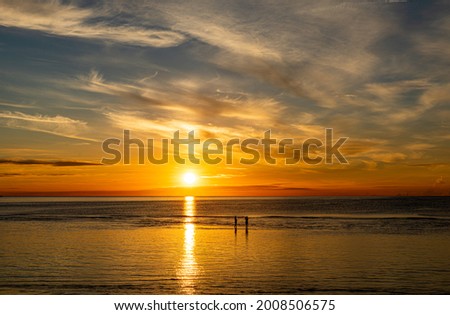 Silhouette, Tourists stand to take pictures on the beach of Hua Hin morning sunrise