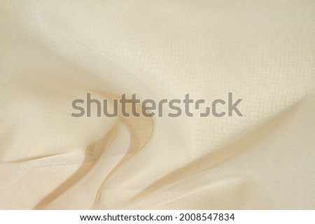 Crumpled fabric background,light airy, transparent fabric texture. Fabric background for design.