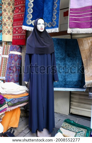 selective focus Racks of shawls and scarves for sale for Muslim women in hijab going on Hajj. hijab dress on mannequin