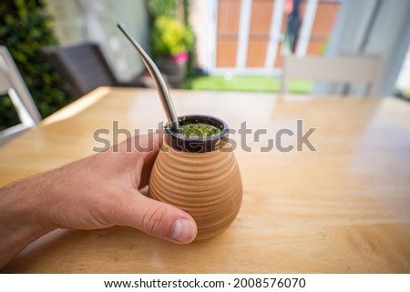 green yerba mate drink tea on a garden table 