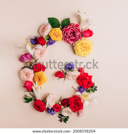 Letter G made of real natural flowers. Flower font. Summer creative concept. Top view. Flat lay