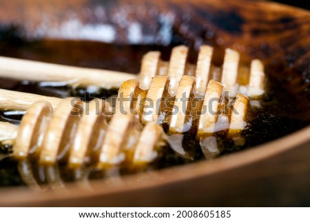 dipped in honey specially made from wood, a homemade rough spoon, sweet bee honey and three wooden spoons that allow you to transfer and pour honey without dripping and spreading