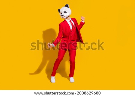 Photo of cheerful carefree panda guy dance wear mask red suit tie footwear isolated on yellow color background