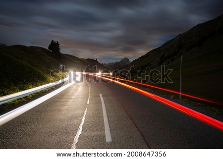 Pass road at night with light streaks from cars on Hochtannbergpass, Vorarlberg, Bregenz Forest, Austria