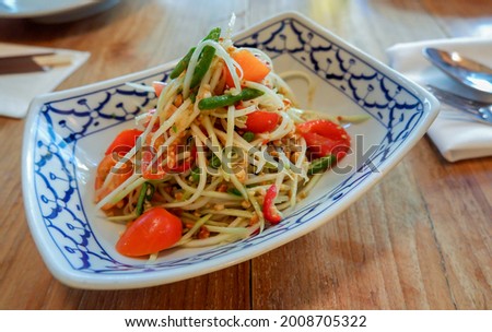 green papaya salad, a spicy salad made from shredded unripe papaya, famous dish eaten throughout Southeast Asia