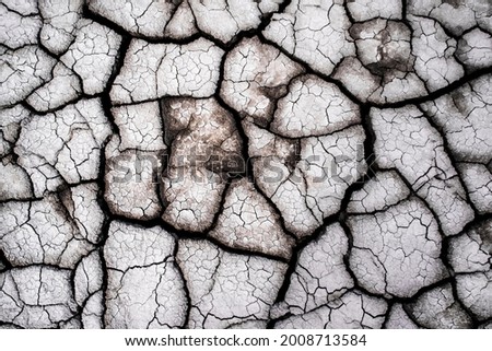 Dry cracked earth as a background close-up. Environmental disaster. Drought. beautiful background full flame pattern crack surface texture, photo for graphic creative design background