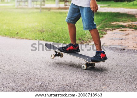 young boy riding a skateboard at a skating rink
