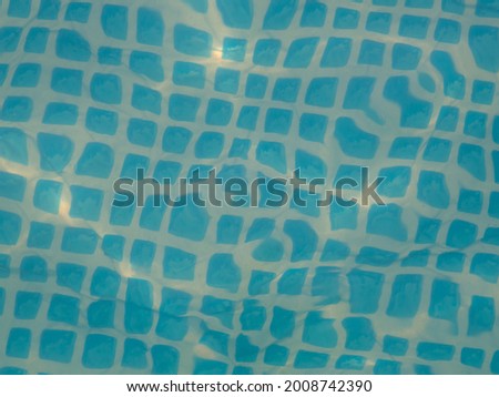 Top view of water ripple in pool with blue tiles place for text