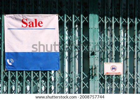 Sale Sign of Commercial Building on Folding Door.