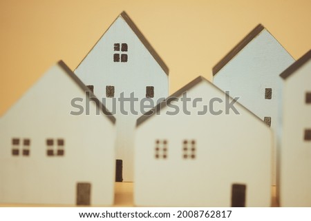 White different sized wooden models of houses, selective focus choose what's the best, house can you afford