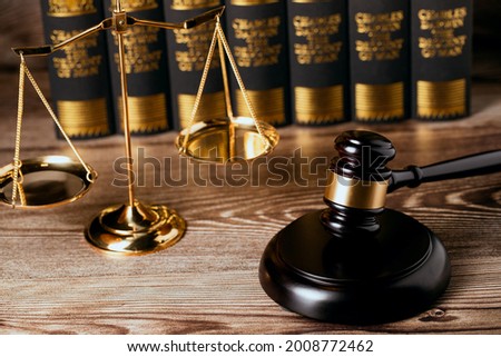 Close up of view Judge gavel, brass scale, law book on a desk wooden at law firm office, law, and justice concept.