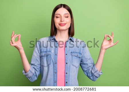 Photo of young girl happy positive smile meditate yoga zen om calm peace isolated over green color background