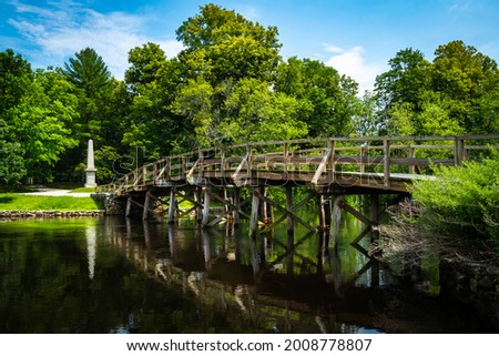 Old North Bridge at Minute Man National Historical Park in Concord, Massachusetts. Tranquil Nature Landscape with Landmark Bridge and Clean River. Peaceful American New England Image. Royalty-Free Stock Photo #2008778807