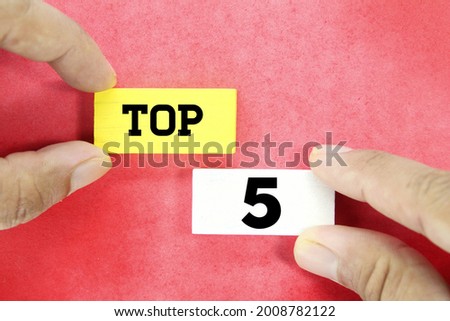hand holding a wooden cube with the word Top 5 Royalty-Free Stock Photo #2008782122