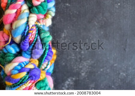 Knitting crochet or wool crafts background with colourful hand spun art yarn Royalty-Free Stock Photo #2008783004