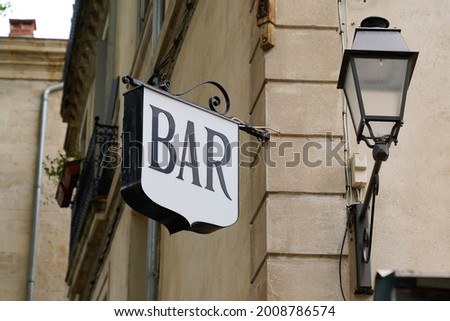 bar sign text on pub in city europe street storefront facade building