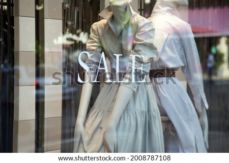 Sale sign at the window shop in the mall	